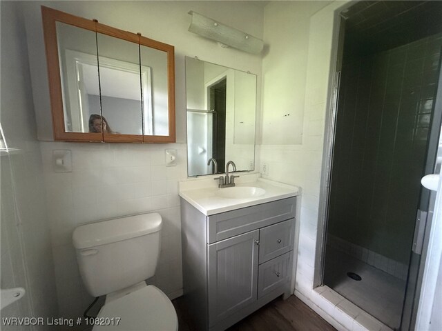 403 Woodland Hills Blvd, Roland, OK 74954 - full bathroom featuring a stall shower, vanity, and tile walls