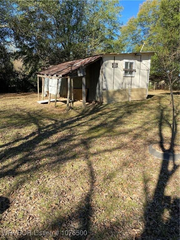 view of outdoor structure with a lawn