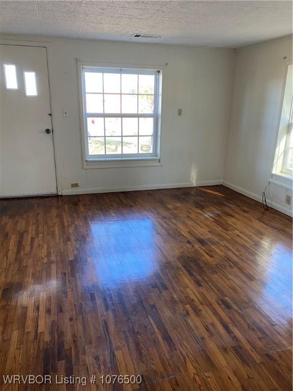 spare room with dark wood-type flooring