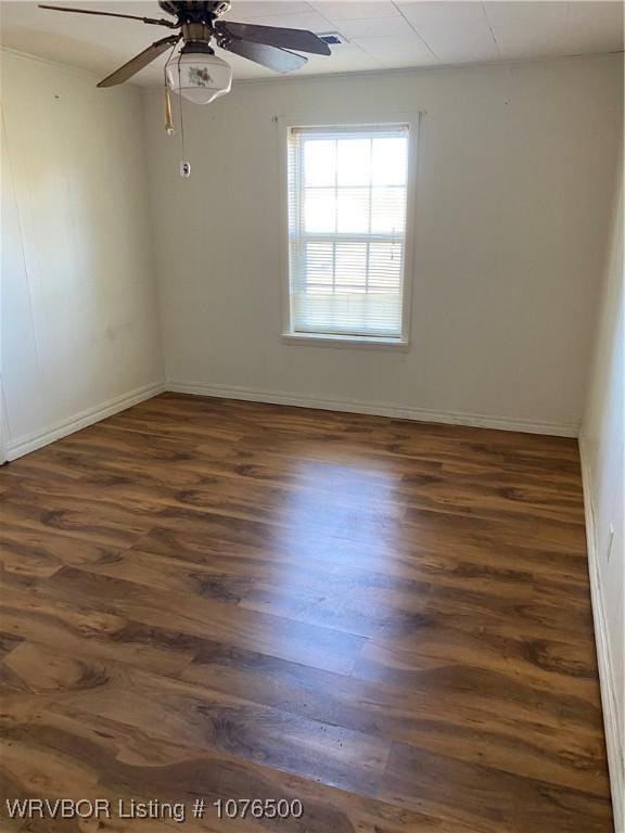 unfurnished room featuring ceiling fan and dark hardwood / wood-style flooring