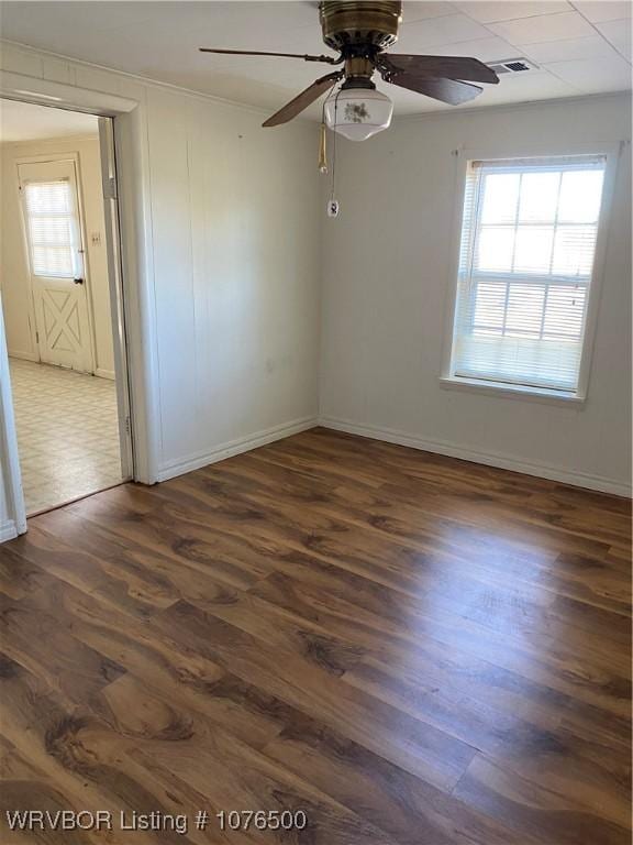 spare room with ceiling fan and dark wood-type flooring