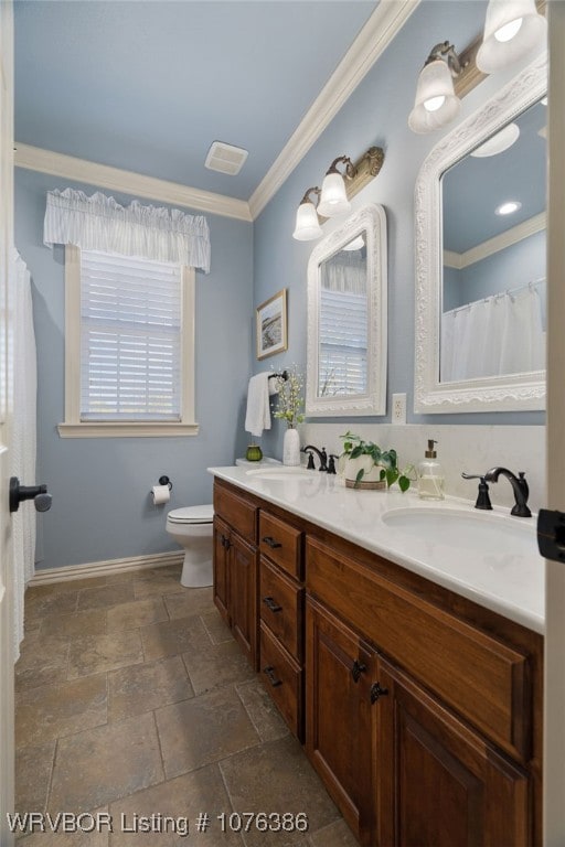 bathroom featuring vanity, toilet, and crown molding