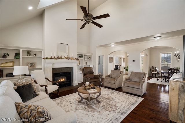 living room with ceiling fan, high vaulted ceiling, and dark hardwood / wood-style floors