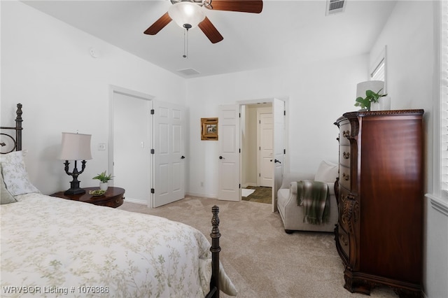 bedroom with ceiling fan and light carpet