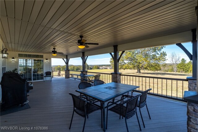 wooden terrace with grilling area and ceiling fan