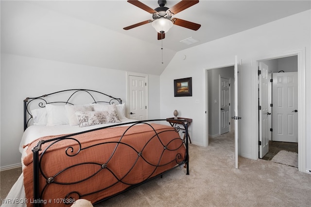 carpeted bedroom featuring ceiling fan and vaulted ceiling