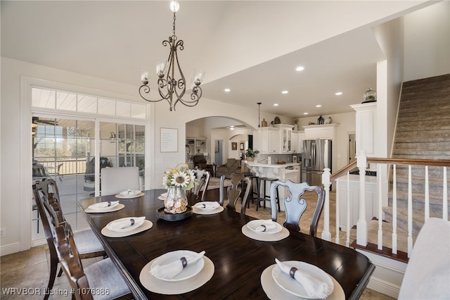 tiled dining room featuring an inviting chandelier