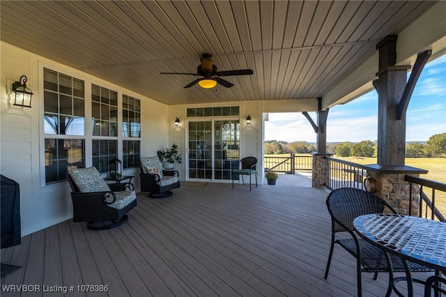 deck featuring ceiling fan and a porch