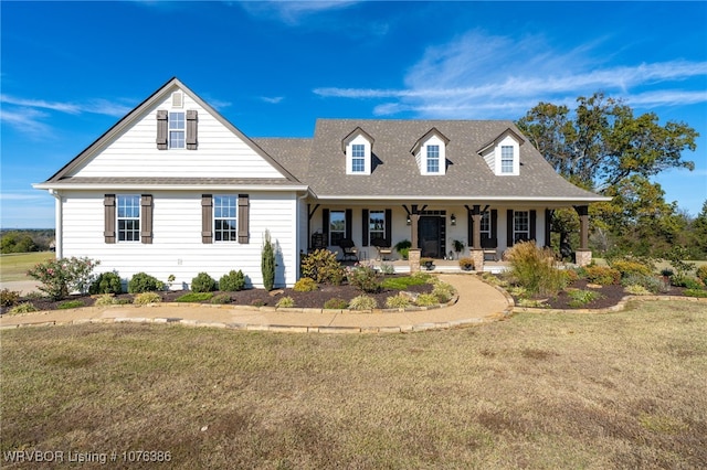 cape cod house featuring a porch and a front lawn