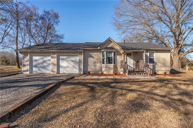 single story home featuring a garage and driveway