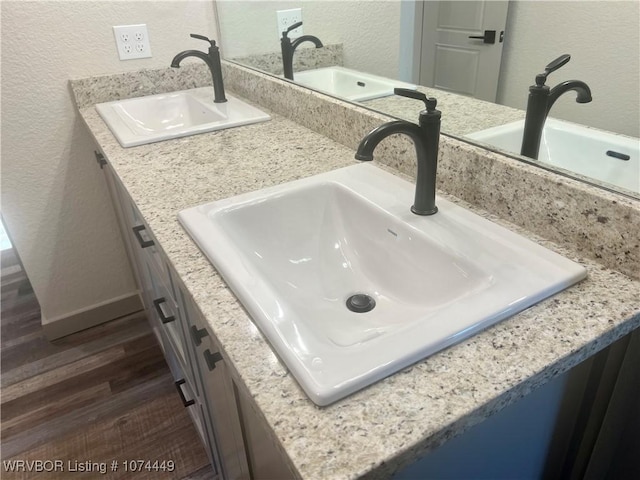 details featuring hardwood / wood-style floors and vanity