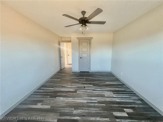 unfurnished room with ceiling fan and dark hardwood / wood-style floors