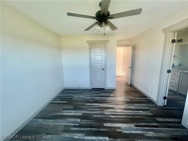 empty room with dark hardwood / wood-style floors and ceiling fan