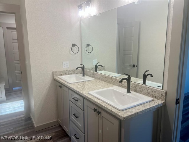 bathroom featuring hardwood / wood-style floors and vanity