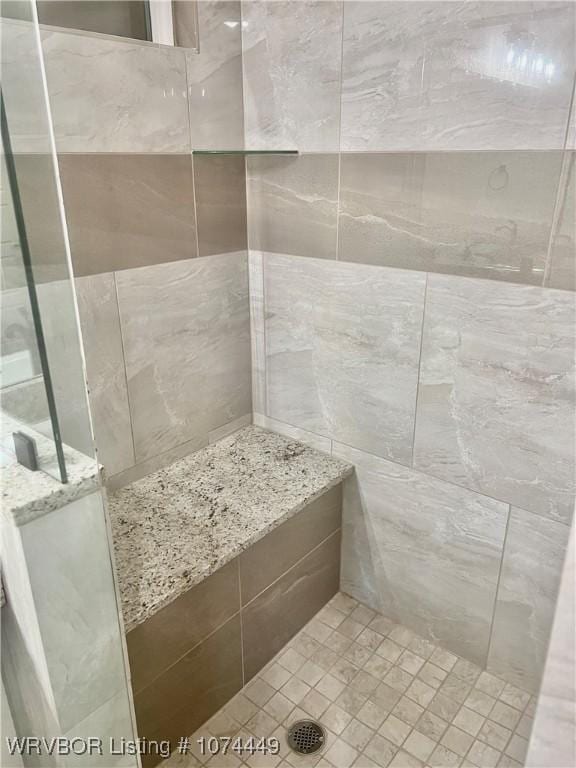 bathroom with a tile shower