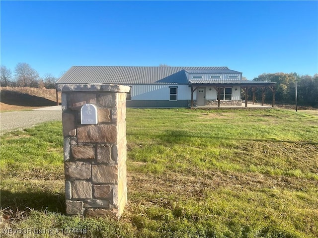 view of front of house with a patio and a front lawn