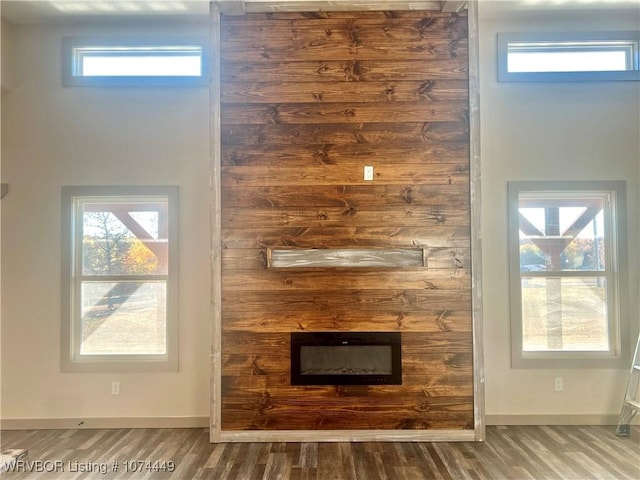 unfurnished living room with a fireplace and hardwood / wood-style floors