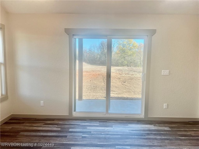 doorway with dark wood-type flooring