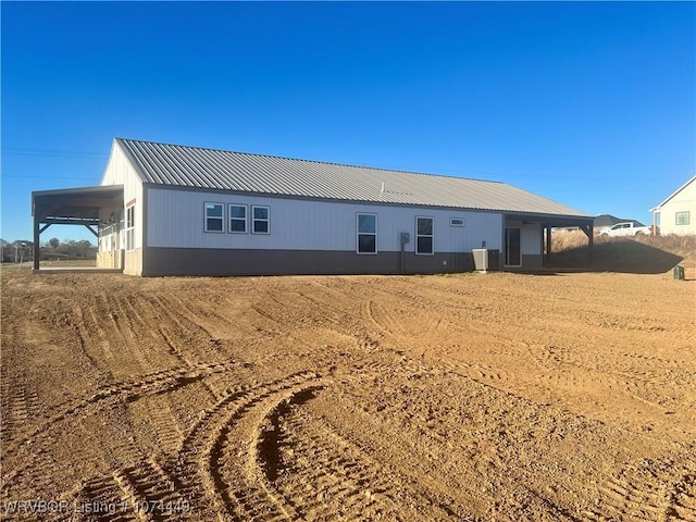 back of house with a carport