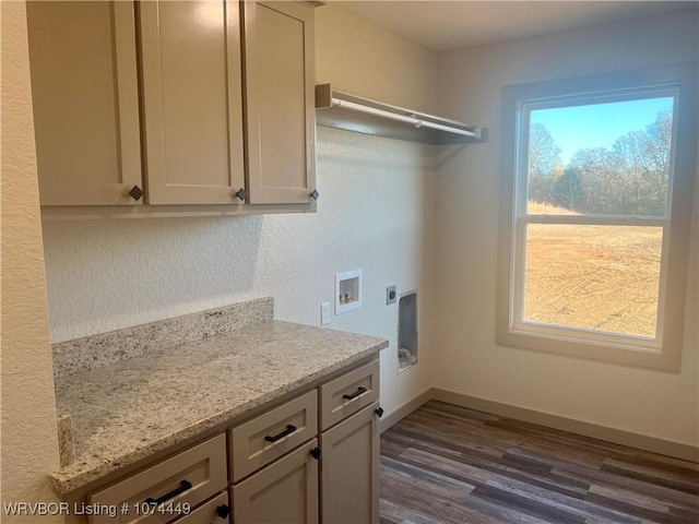 clothes washing area with hookup for an electric dryer, washer hookup, dark hardwood / wood-style flooring, and cabinets