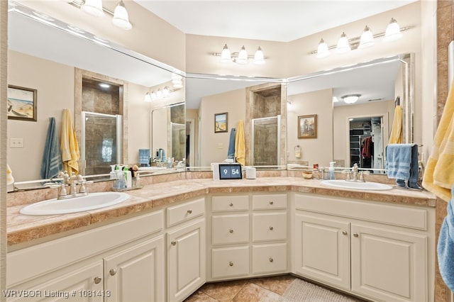 2110 Parkway Cir, Van Buren, AR 72956 - bathroom featuring a shower stall, double vanity, tile patterned flooring, and a spacious closet