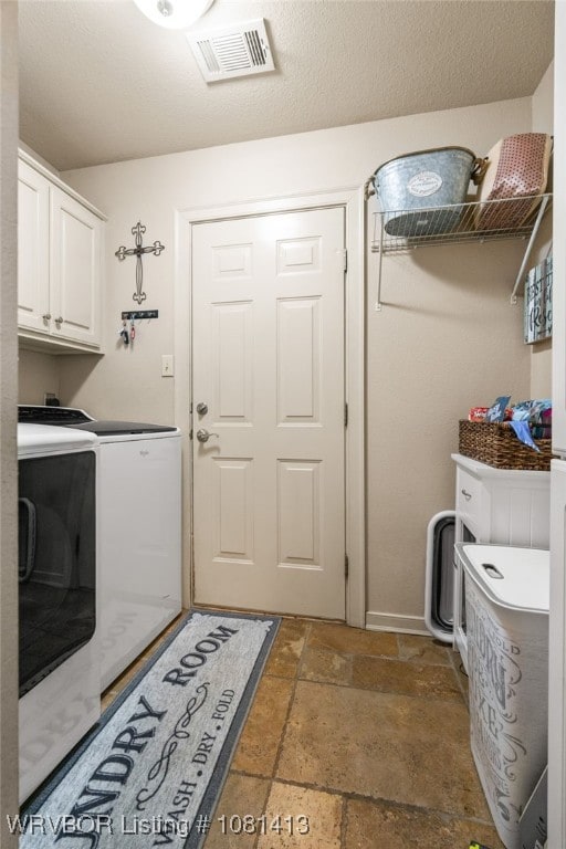 2110 Parkway Cir, Van Buren, AR 72956 - washroom with cabinet space, separate washer and dryer, stone tile floors, and baseboards