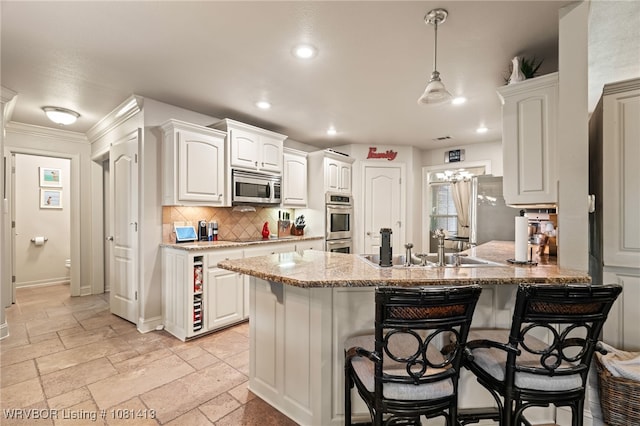 2110 Parkway Cir, Van Buren, AR 72956 - kitchen featuring appliances with stainless steel finishes, a breakfast bar, backsplash, a peninsula, and recessed lighting