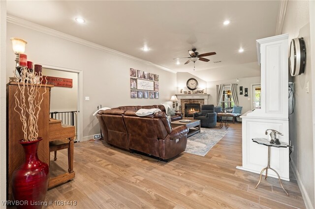 2110 Parkway Cir, Van Buren, AR 72956 - living area with ceiling fan, light wood finished floors, a stone fireplace, crown molding, and baseboards