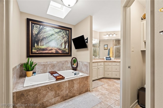 2110 Parkway Cir, Van Buren, AR 72956 - bathroom with a skylight, vanity, a bath, an enclosed shower, and tile patterned floors