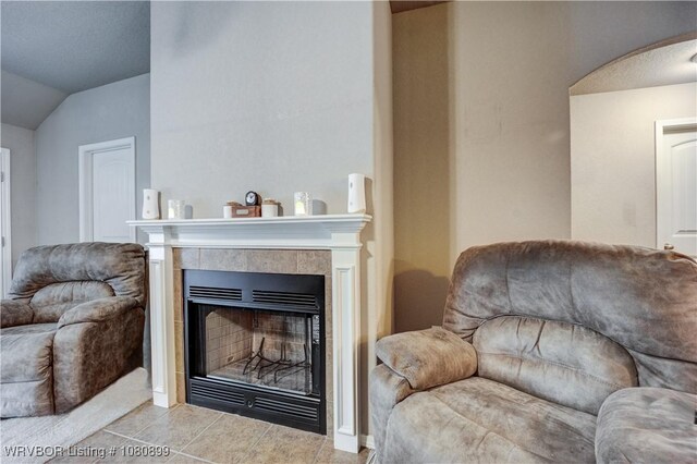2005 Scarlet Oak Dr, Van Buren, AR 72956 - living area featuring vaulted ceiling, tile patterned flooring, a tile fireplace, and arched walkways