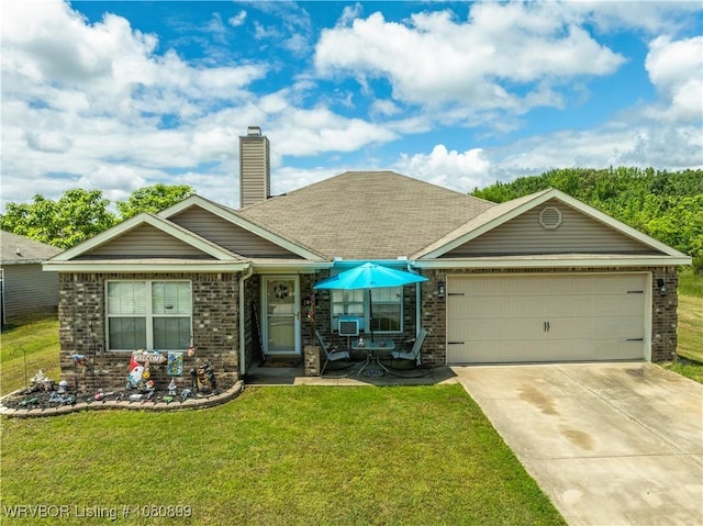 2005 Scarlet Oak Dr, Van Buren, AR 72956 - view of front of home featuring brick siding, concrete driveway, a garage, a front lawn, and a chimney