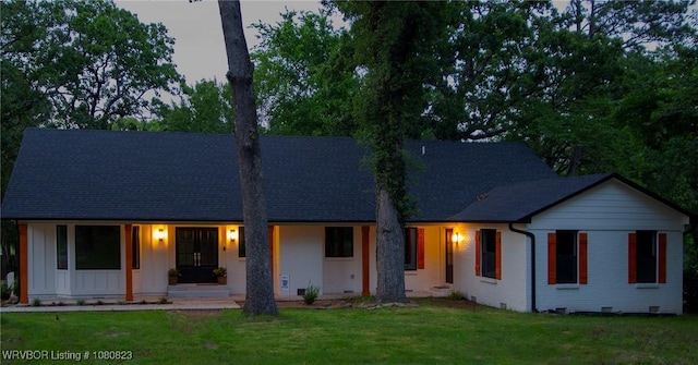 6001 Bolton Rd, Fort Smith, AR 72903 - view of front of house with a front yard, board and batten siding, covered porch, roof with shingles, and brick siding