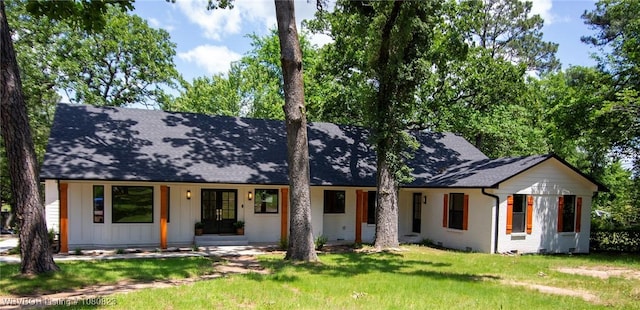 6001 Bolton Rd, Fort Smith, AR 72903 - view of front of house featuring a front lawn, board and batten siding, a porch, roof with shingles, and brick siding