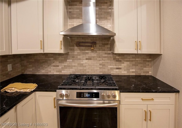 6001 Bolton Rd, Fort Smith, AR 72903 - kitchen with wall chimney exhaust hood, stainless steel range with gas cooktop, decorative backsplash, white cabinetry, and dark stone counters