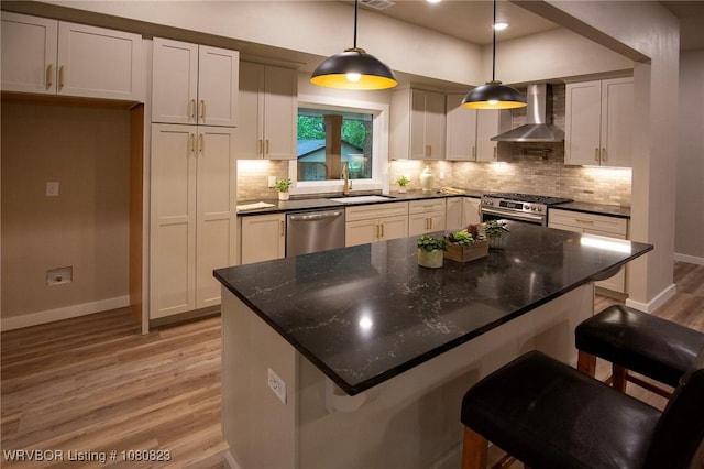 6001 Bolton Rd, Fort Smith, AR 72903 - kitchen with wall chimney exhaust hood, appliances with stainless steel finishes, a sink, light wood-style floors, and baseboards