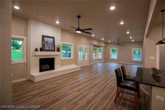 6001 Bolton Rd, Fort Smith, AR 72903 - unfurnished living room featuring a ceiling fan, wood finished floors, a brick fireplace, baseboards, and recessed lighting