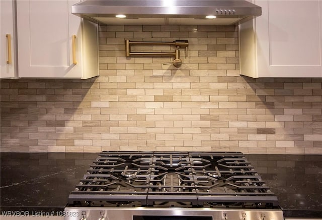 6001 Bolton Rd, Fort Smith, AR 72903 - kitchen with decorative backsplash, white cabinets, and ventilation hood
