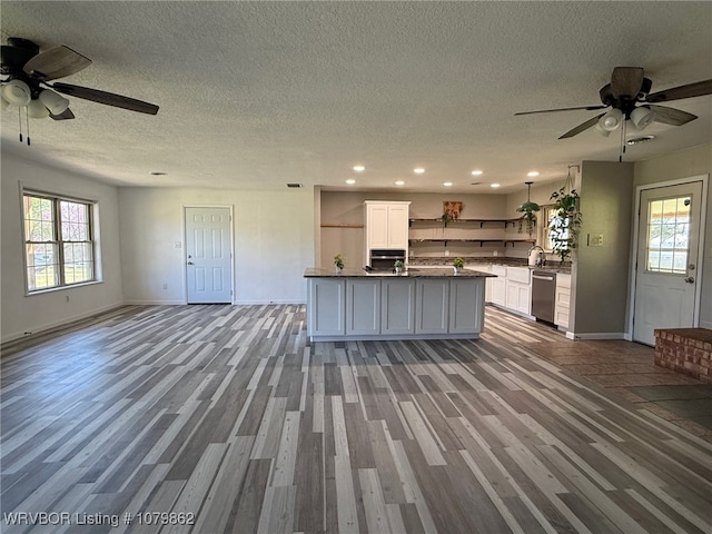 1611 Kimberling Hill Dr, Alma, AR 72921 - kitchen featuring open shelves, open floor plan, dark countertops, ceiling fan, and a textured ceiling