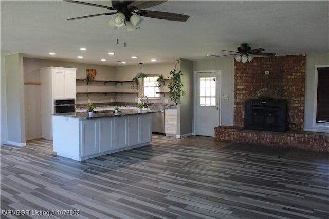 kitchen featuring white cabinets, open shelves, a ceiling fan, and appliances with stainless steel finishes