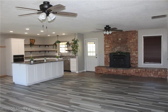 kitchen featuring white cabinetry, open shelves, visible vents, a ceiling fan, and wall oven