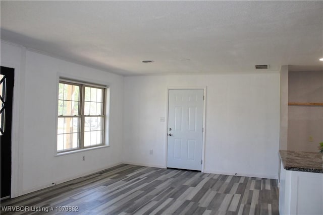 interior space with light wood-style flooring and visible vents