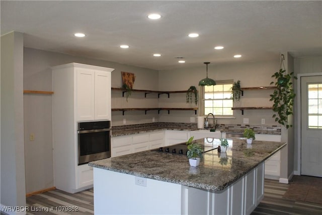 kitchen featuring white cabinetry, oven, open shelves, and a wealth of natural light