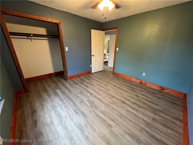 1611 Kimberling Hill Dr, Alma, AR 72921 - unfurnished bedroom with wood finished floors, a closet, a textured ceiling, and ceiling fan