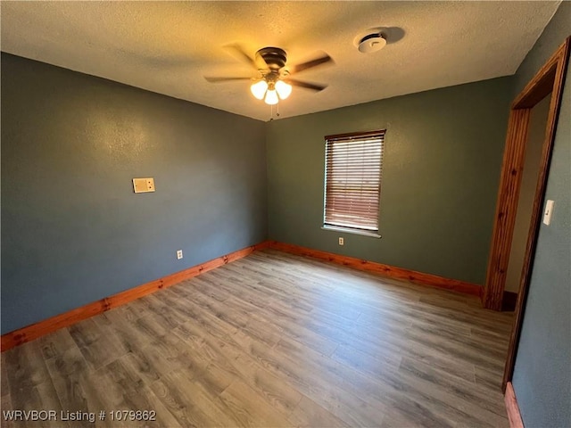 1611 Kimberling Hill Dr, Alma, AR 72921 - spare room with a ceiling fan, a textured ceiling, and wood finished floors