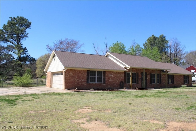 ranch-style home with a front yard, concrete driveway, fence, an attached garage, and brick siding