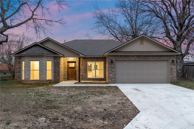 single story home featuring driveway, brick siding, roof with shingles, and an attached garage