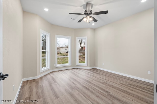 empty room with visible vents, baseboards, and wood finished floors