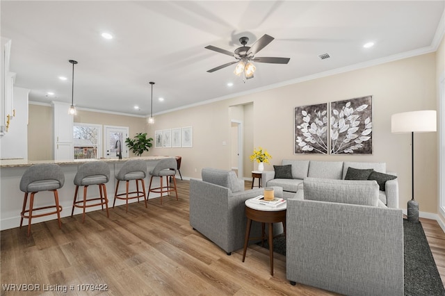 3115 Spradling Ave, Fort Smith, AR 72904 - living room featuring recessed lighting, wood finished floors, ornamental molding, and ceiling fan