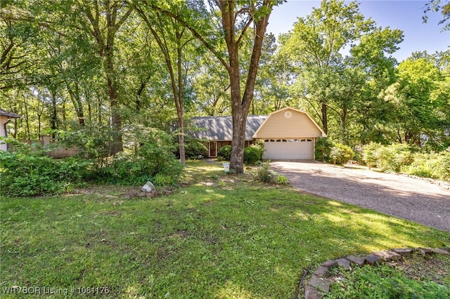 10519 Meandering Ct, Fort Smith, AR 72903 - view of front of house featuring asphalt driveway, a front yard, an attached garage, and metal roof