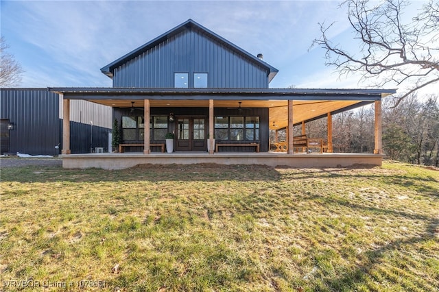 rear view of property featuring a lawn